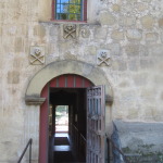 Entrance to the side of the church from the cemetery. We were surprised to see skull and cross bones over the doors but apparently at the time it was a symbol of a cemetery - not of pirates