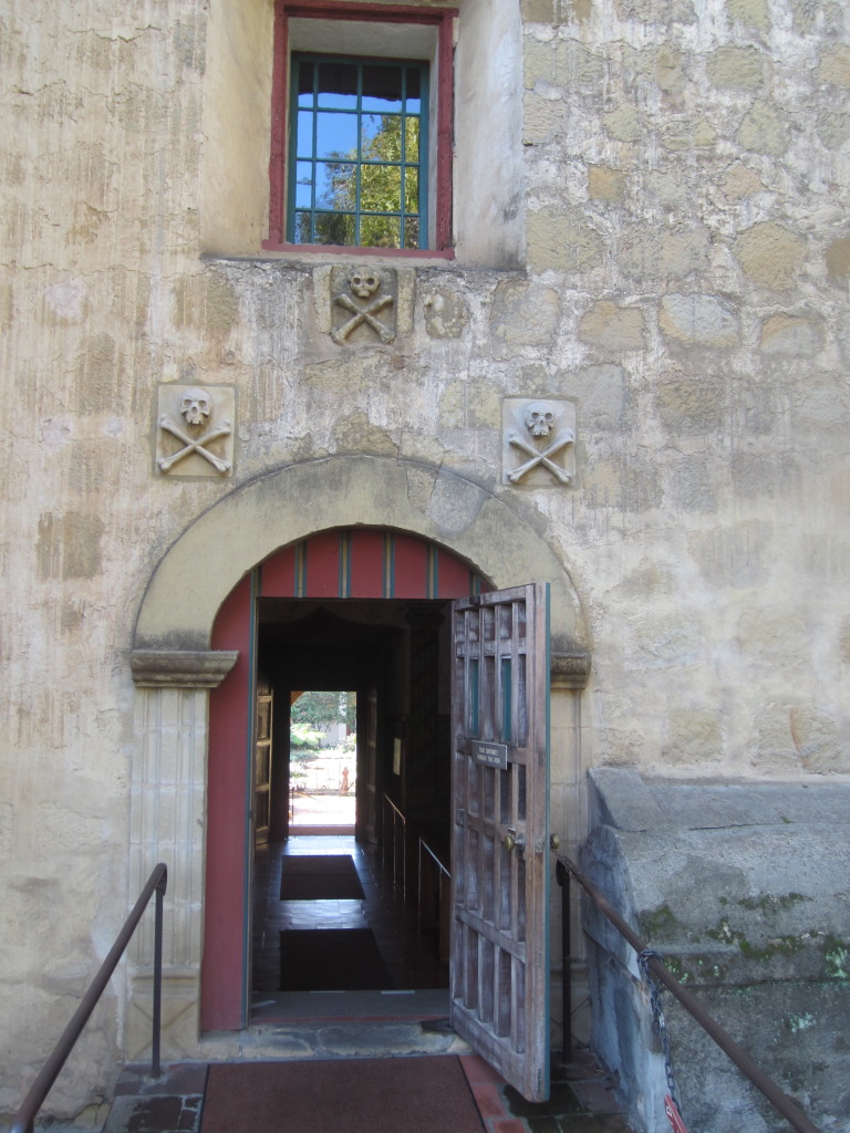 Entrance to the side of the church from the cemetery. We were surprised to see skull and cross bones over the doors but apparently at the time it was a symbol of a cemetery - not of pirates
