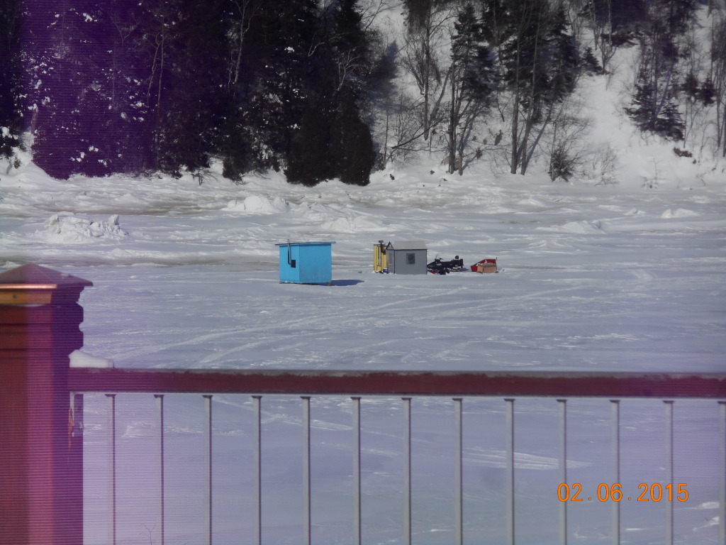two lonely and cold looking fish huts