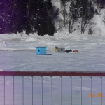 two lonely and cold looking fish huts