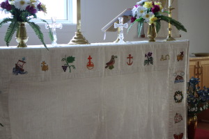 Frontal hand embroidered  with flowers, birds and fish of the area. Made me think of our beautiful needle point in Tadoussac